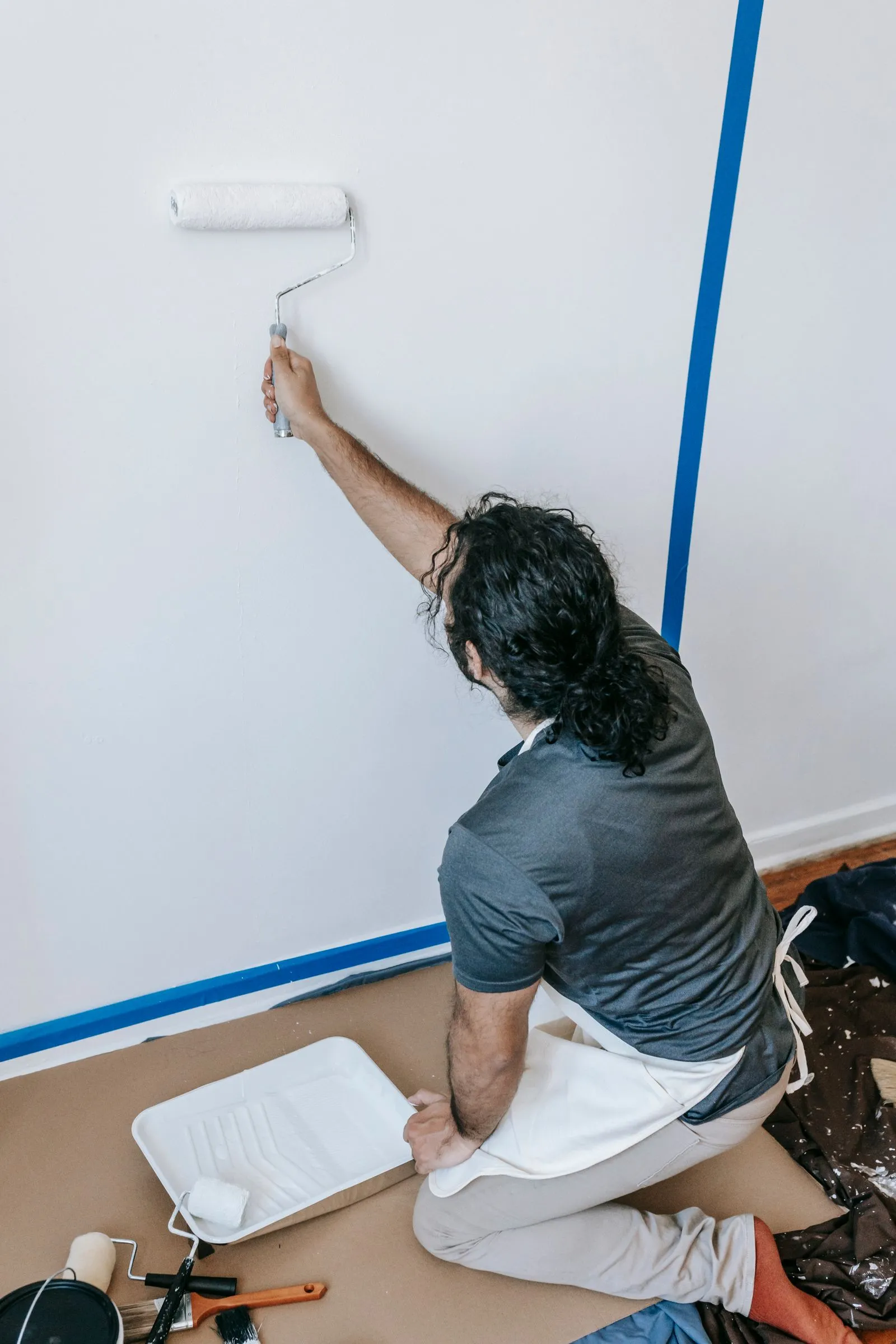 Painter rolling a fresh coat on an interior wall